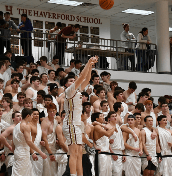 A basketball player takes a shot with an army of fans dressed for a toga party cheering him on. Photo courtesy of kanesfskycaptures